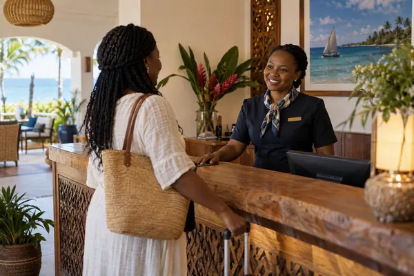 Hotel receptionist welcoming a guest