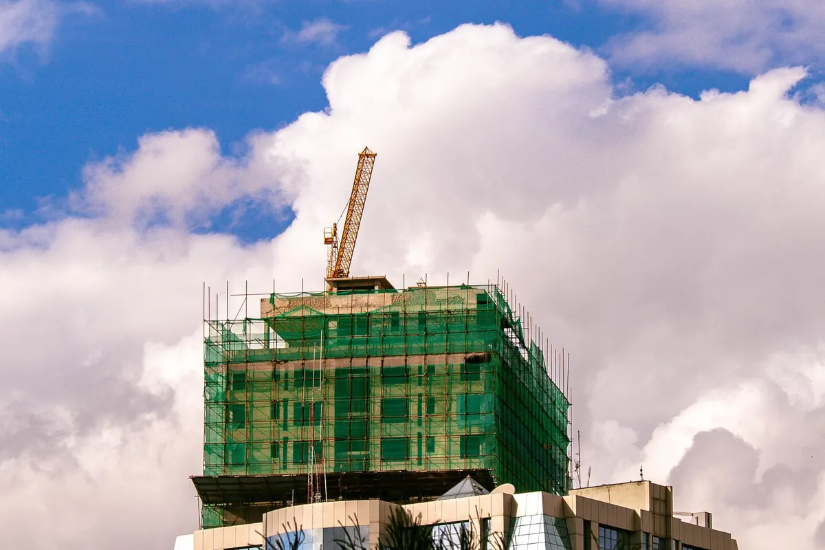 A tall building under construction with a crane in Nairobi