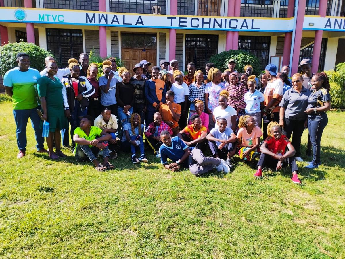 Mwala TVC trainees and staff in front of the college's main building